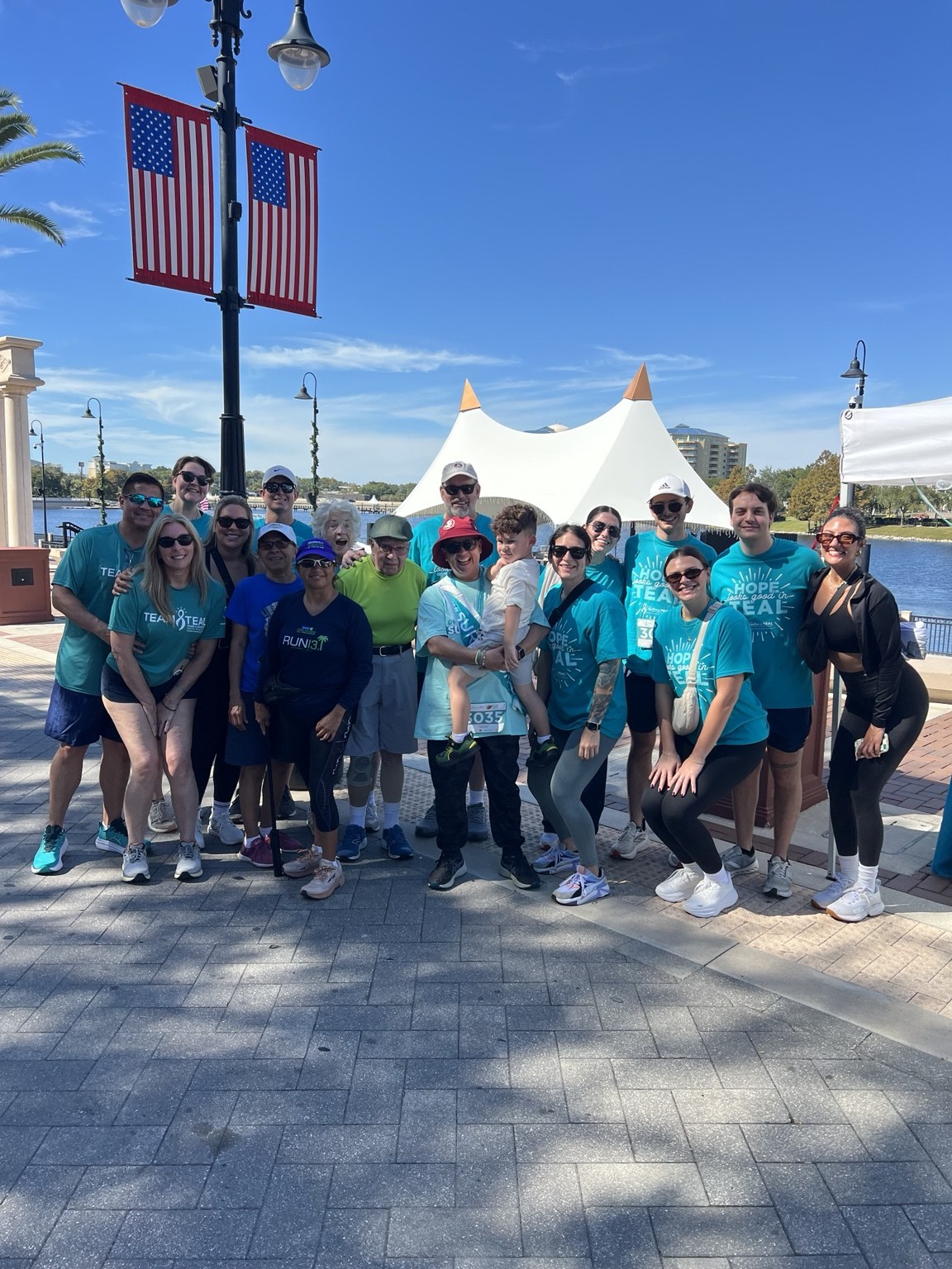 Our group gathered beside the lake at a previous Together in Teal event